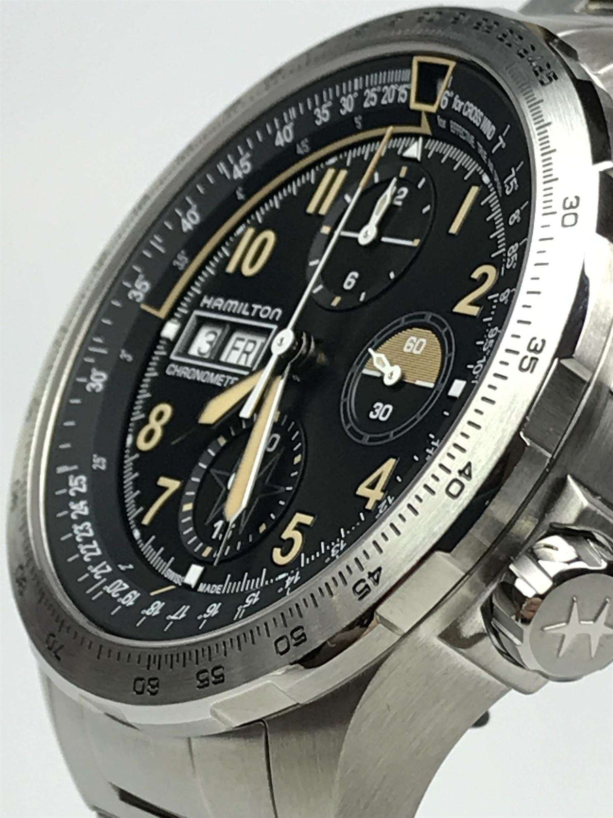 Men's steel chronograph watch angled view, black dial with gold hands and subdials, automatic