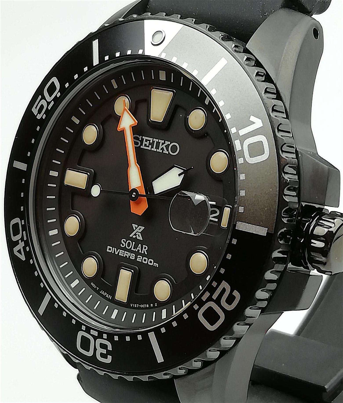 Black dial solar diver's watch with black bezel, orange hands, and rubber strap.