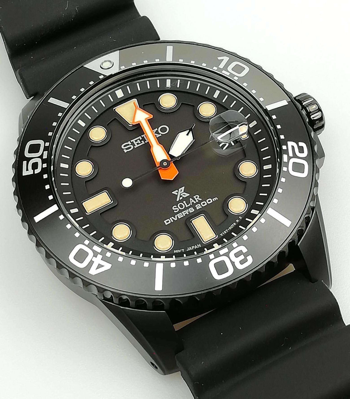 Black dial solar diver's watch with numbered bezel and orange-accent hands.