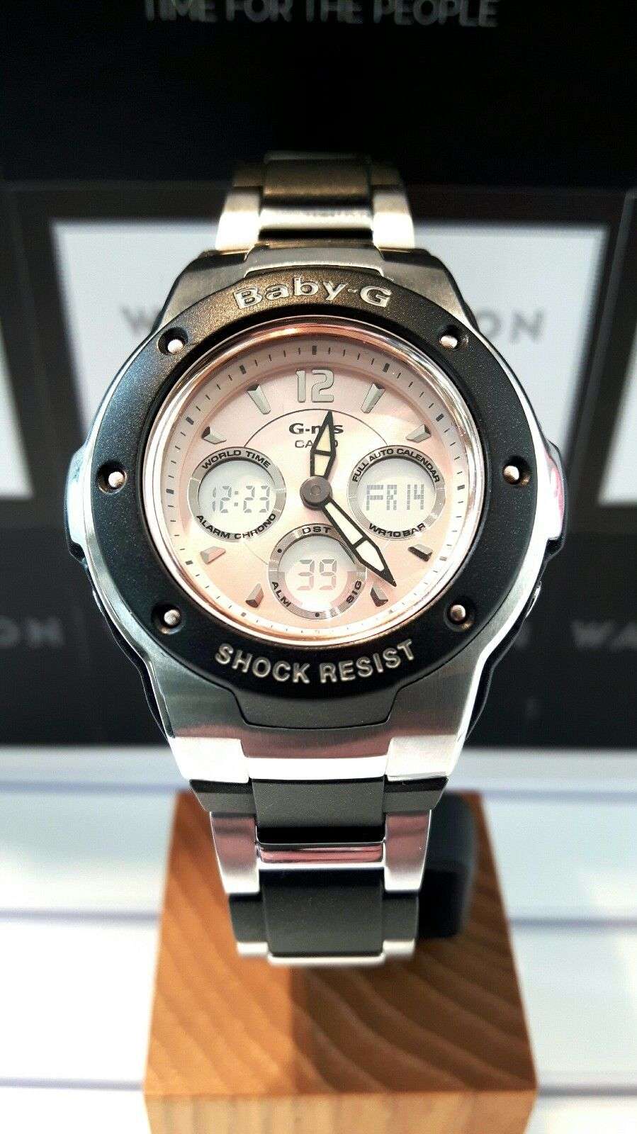 Baby-G women's wristwatch with black bezel, steel bracelet, pink dial and markers