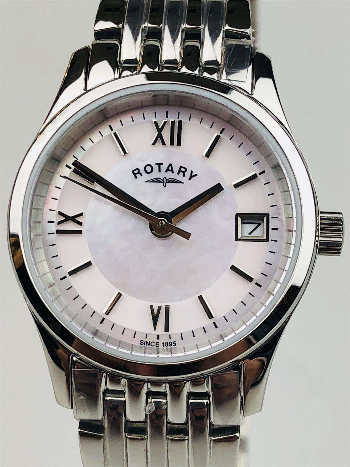 Stainless steel ladies wristwatch with mother-of-pearl dial, black hands, and metal link bracelet