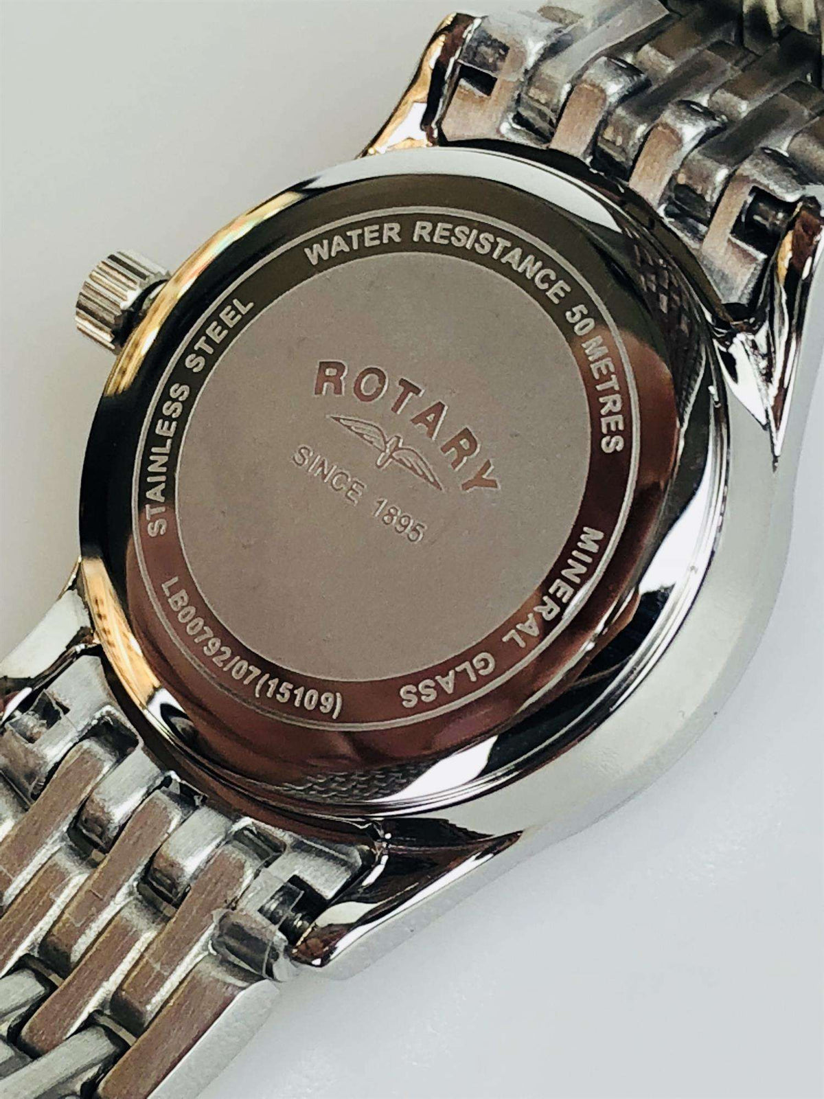 Stainless steel watch case back with “WATER RESISTANCE 50 METERS” and brand mark