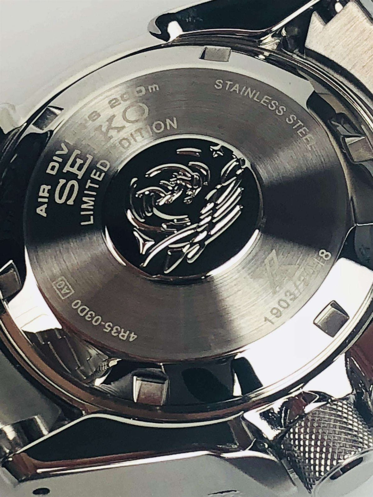 Stainless steel caseback with engraved diver emblem and limited edition text