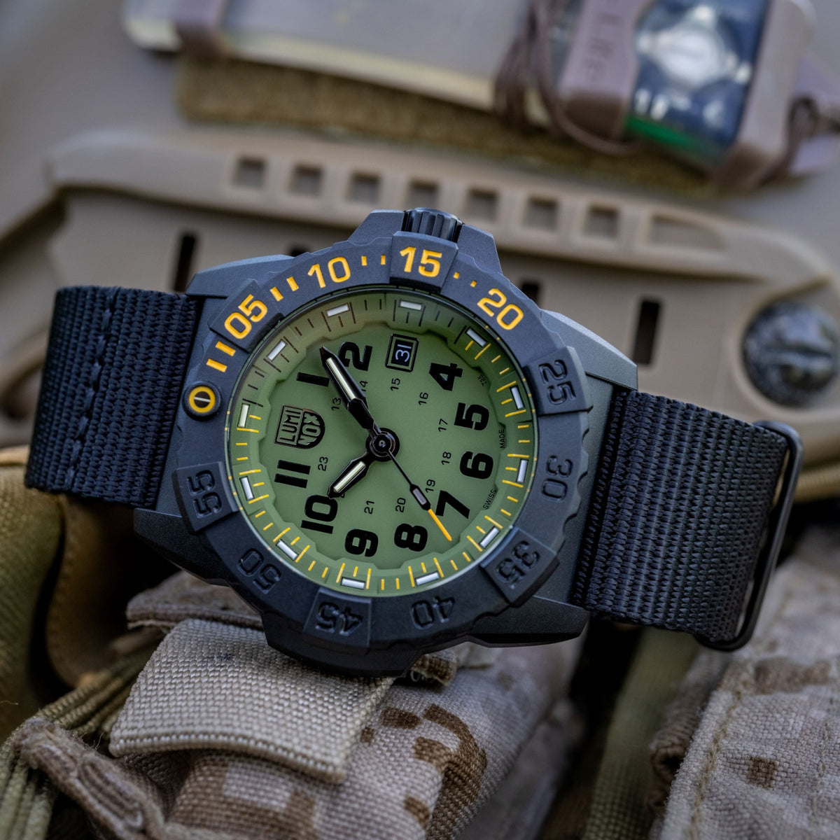 Men's quartz diver watch with blue bezel, green dial, and dark rubber strap