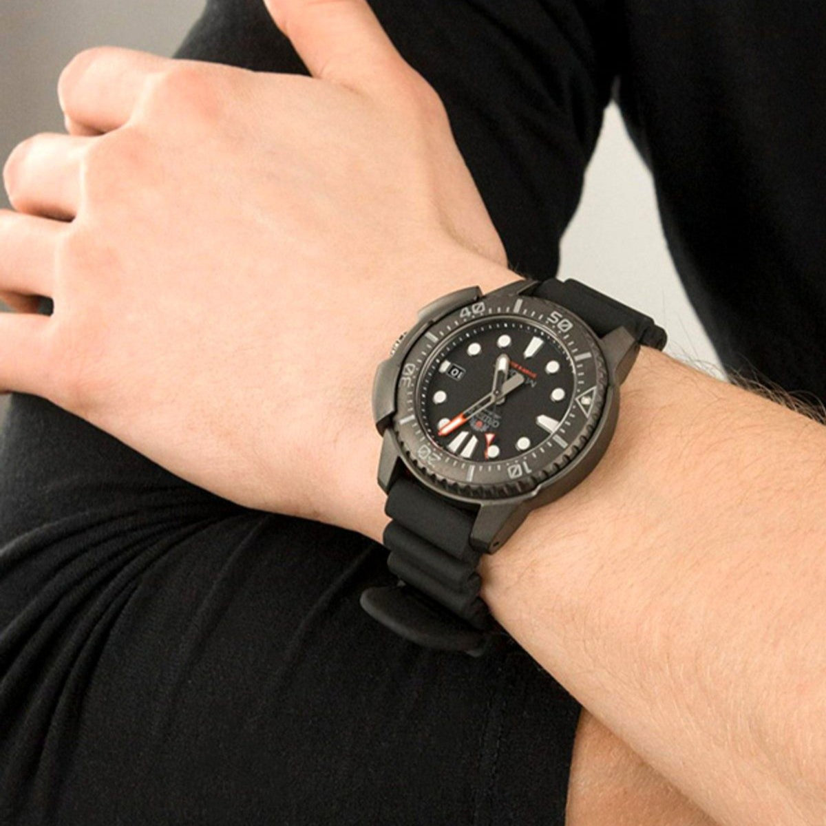 Orient M-Force automatic watch worn on wrist with black silicone strap and dark dial