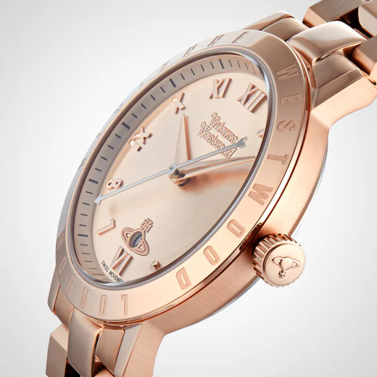 Rose gold watch face close-up with Roman numerals, cream dial, and blue seconds hand