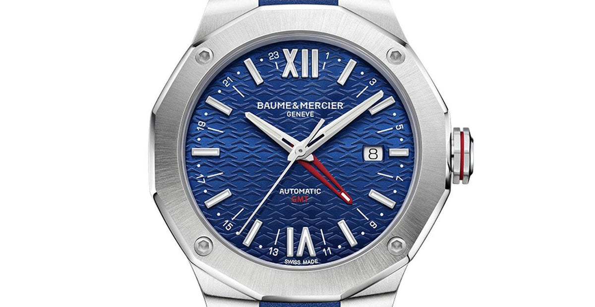 Men's blue GMT automatic watch close-up: blue textured dial, steel case, blue rubber strap