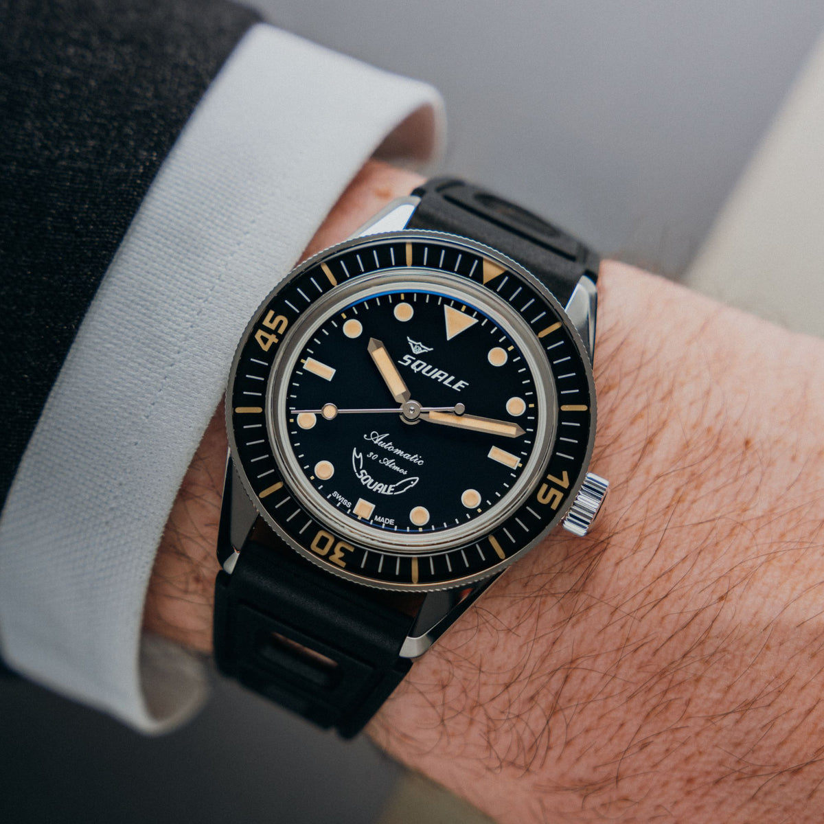 Men's wristwatch with black dial and black rubber strap, gold-tone hands and markers