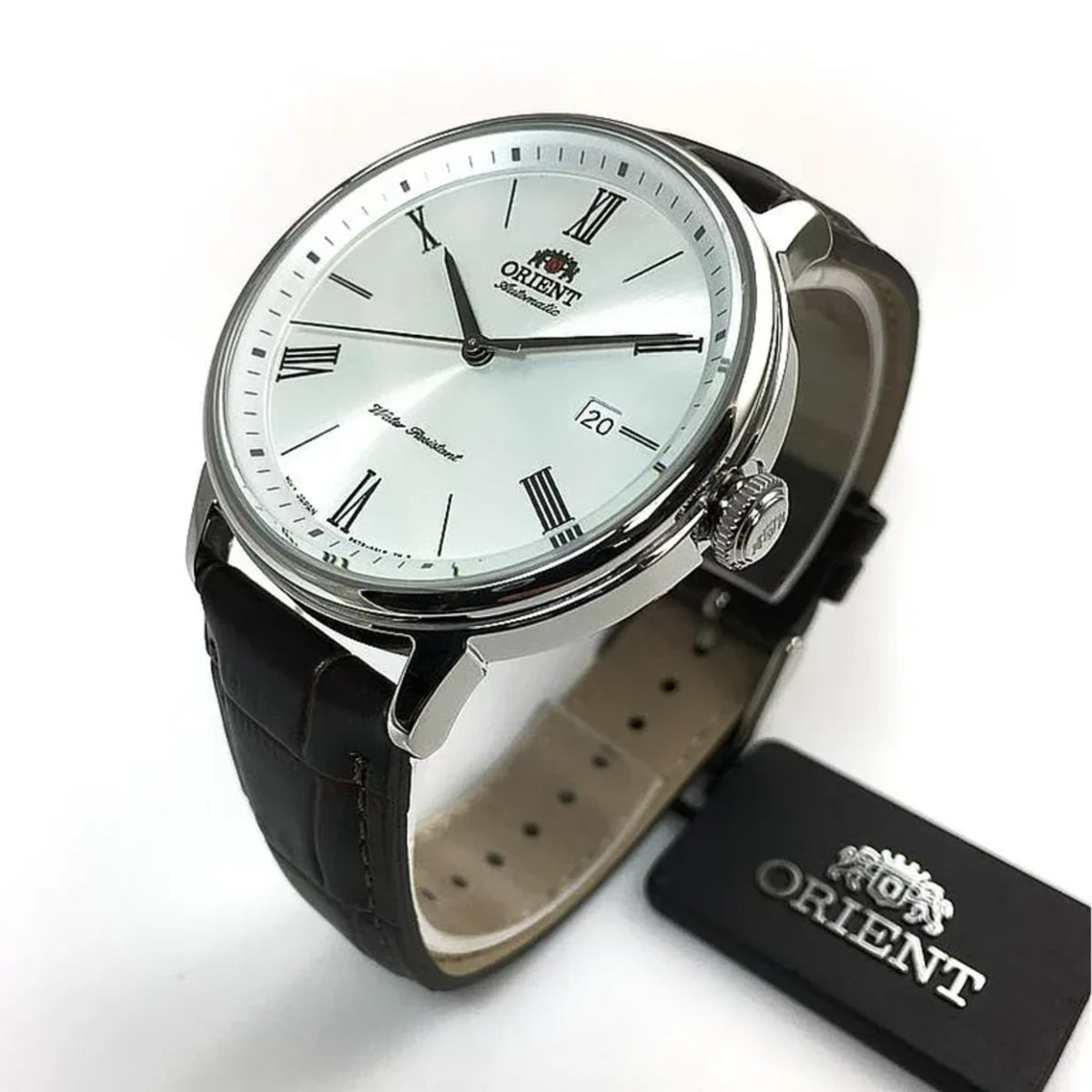 Men's automatic watch with silver case, white dial, Roman numerals, and leather strap