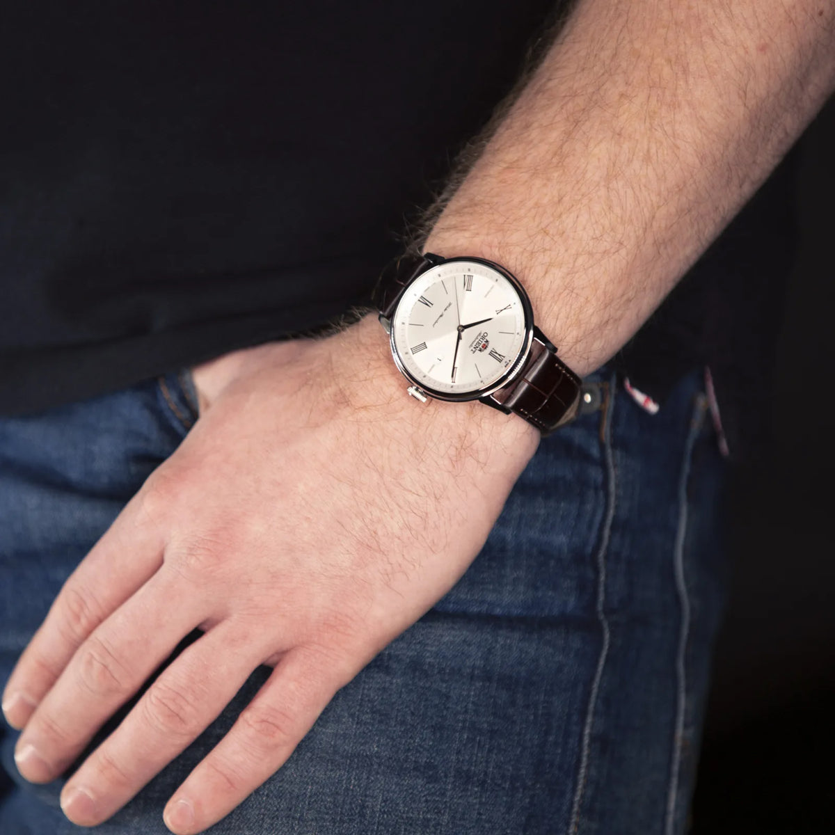 Men's automatic watch with white dial and dark brown leather strap on wrist