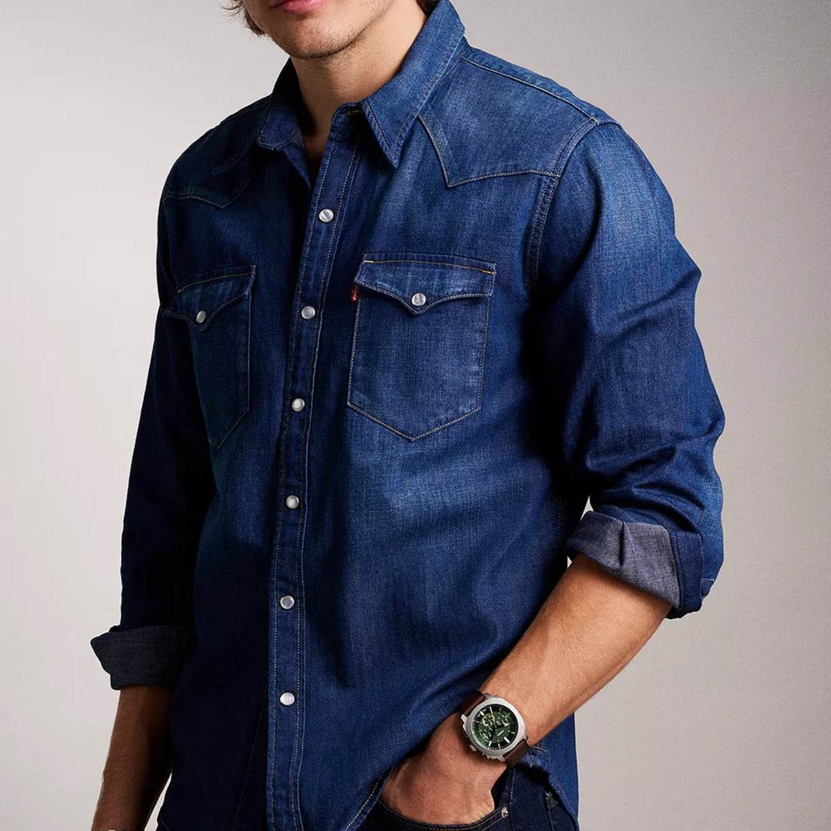 On-wrist lifestyle view of the Fossil Machine FS6100 mens watch paired with a denim shirt