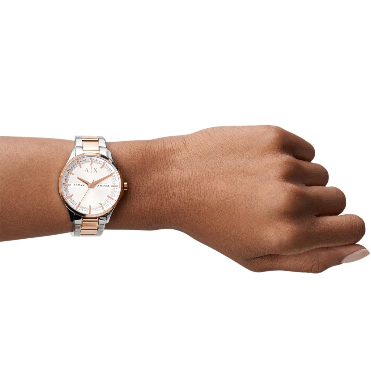 Two-tone ladies quartz watch worn on wrist with white dial and metal bracelet