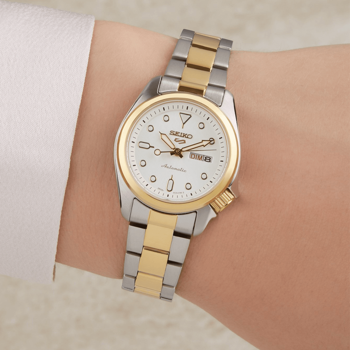 Two-tone stainless steel ladies watch with white dial, gold bezel, day-date window