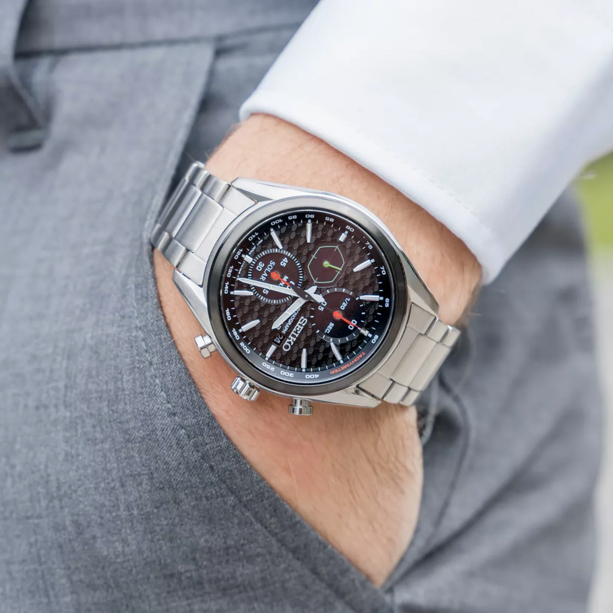 Seiko solar chronograph watch on wrist, black dial, stainless steel bracelet