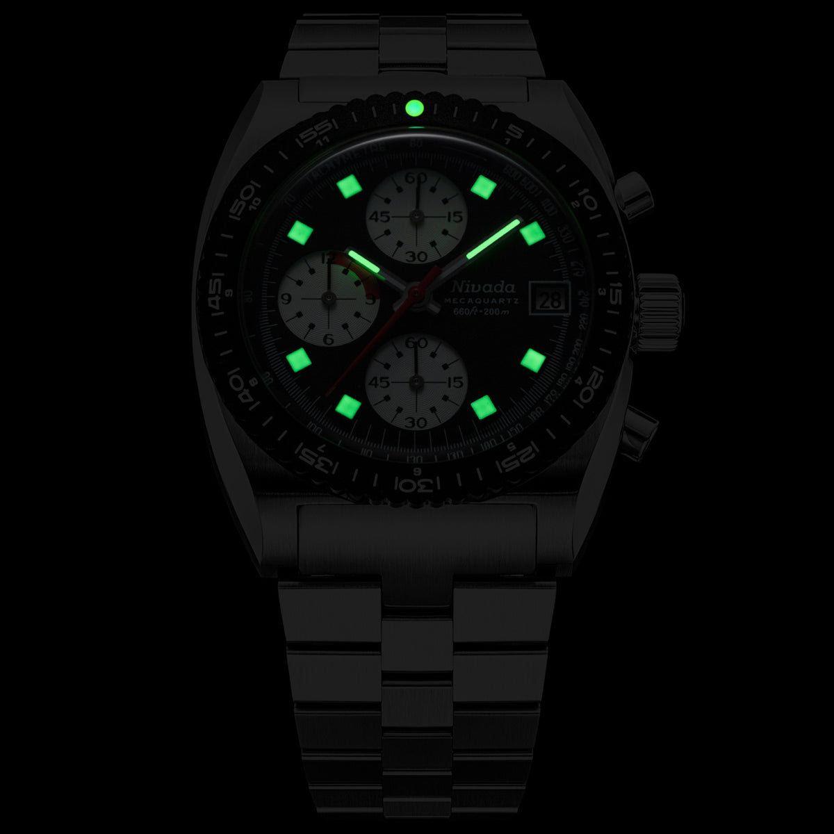 Nivada Grenchen Autochron Mecaquartz Chronograph 77007Q45 showing a black dial, steel bracelet, green lume markers, and a date window on a low-light setting