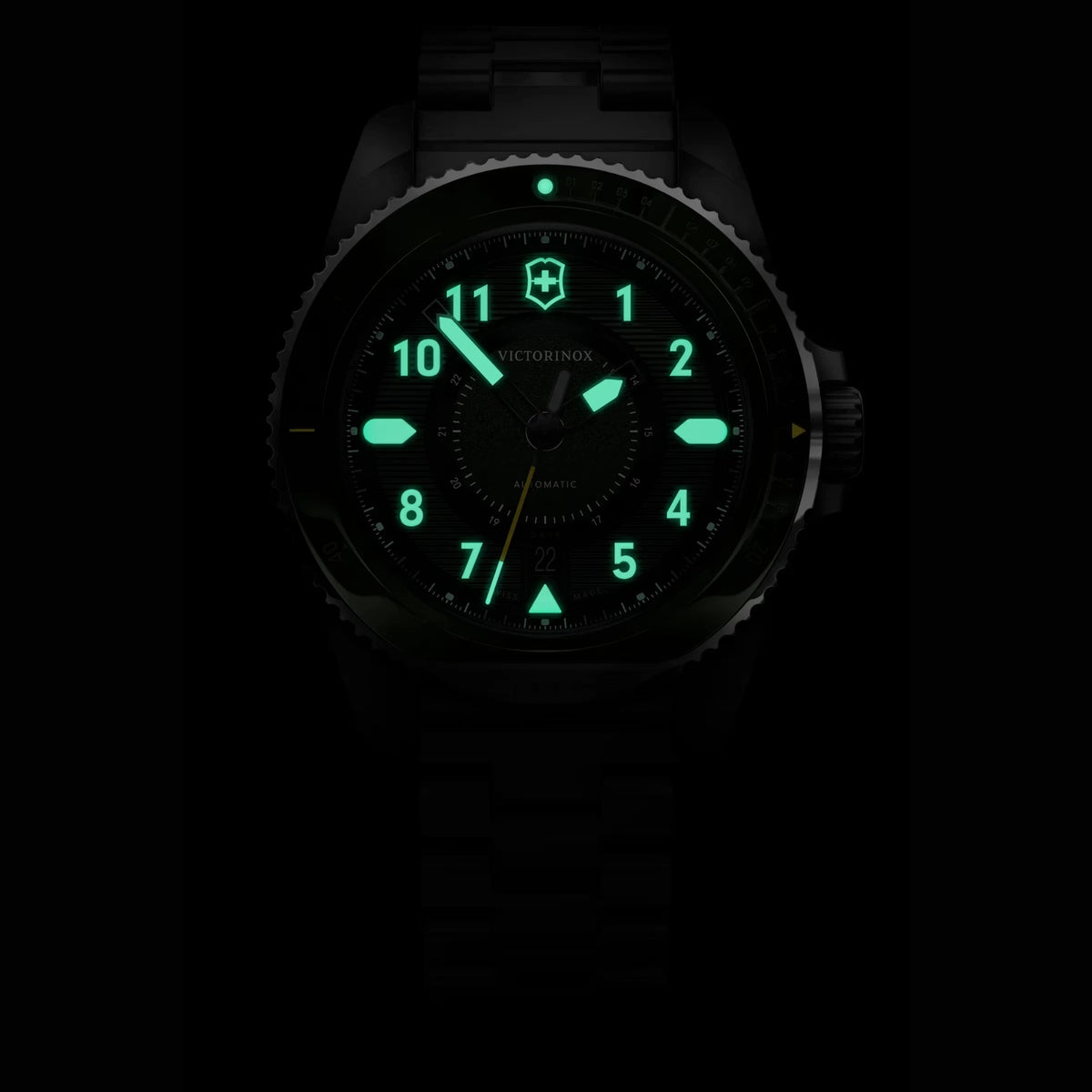 Victorinox Journey 1884 242015 green dial automatic watch in darkness showing glowing green lume hands and markers