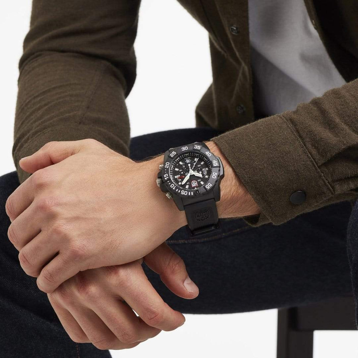 Luminox chronograph watch on wrist with black rubber strap and black dial