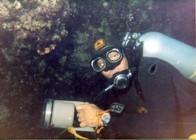 Archival photo of a scuba diver exploring underwater reefs wearing a Squale dive watch