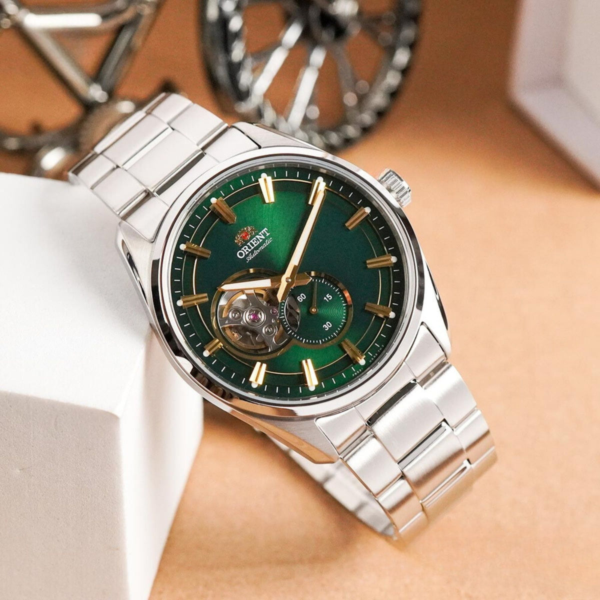 Angle shot of the Orient Stretto RA-AR0008E30B resting on a white display block to highlight its vibrant green dial and steel link bracelet