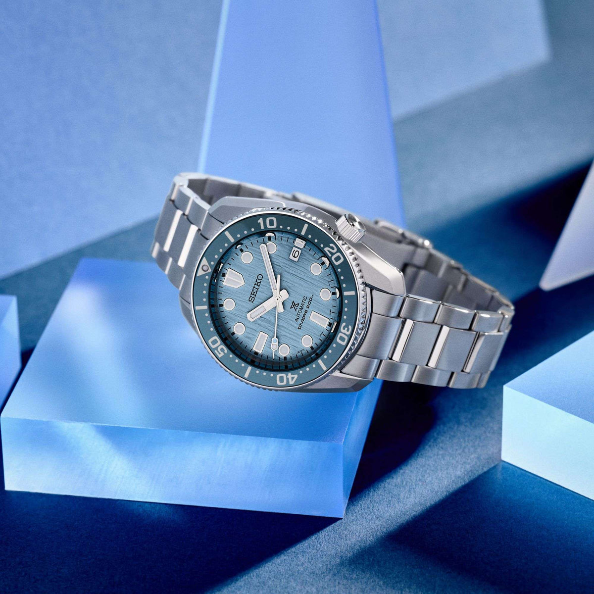 Men's stainless steel diver watch side view with blue dial and crown at 3 o'clock