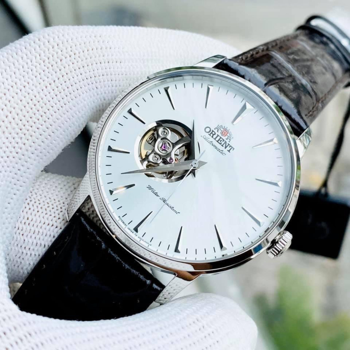 Orient automatic watch on black leather strap with white open-heart dial