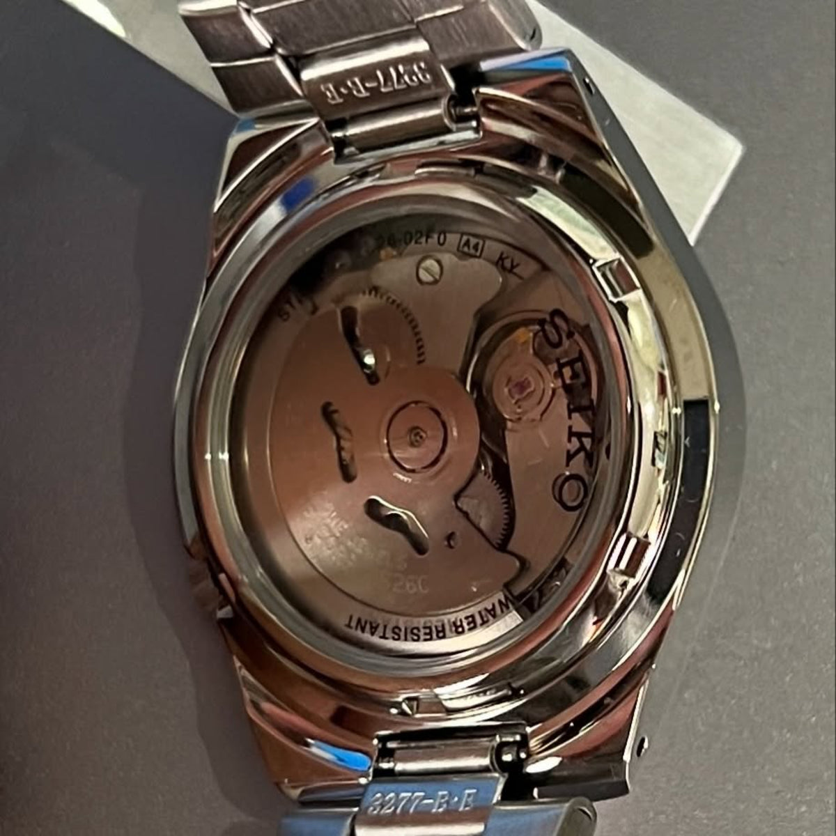 Seiko 5 SNK601K1 mens automatic watch showing a see-through case back and internal movement