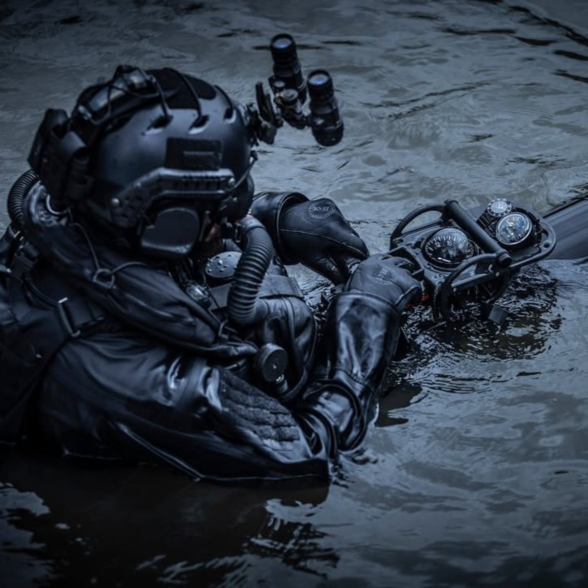 Military tactical diver in full gear wearing a waterproof Luminox dive watch underwater