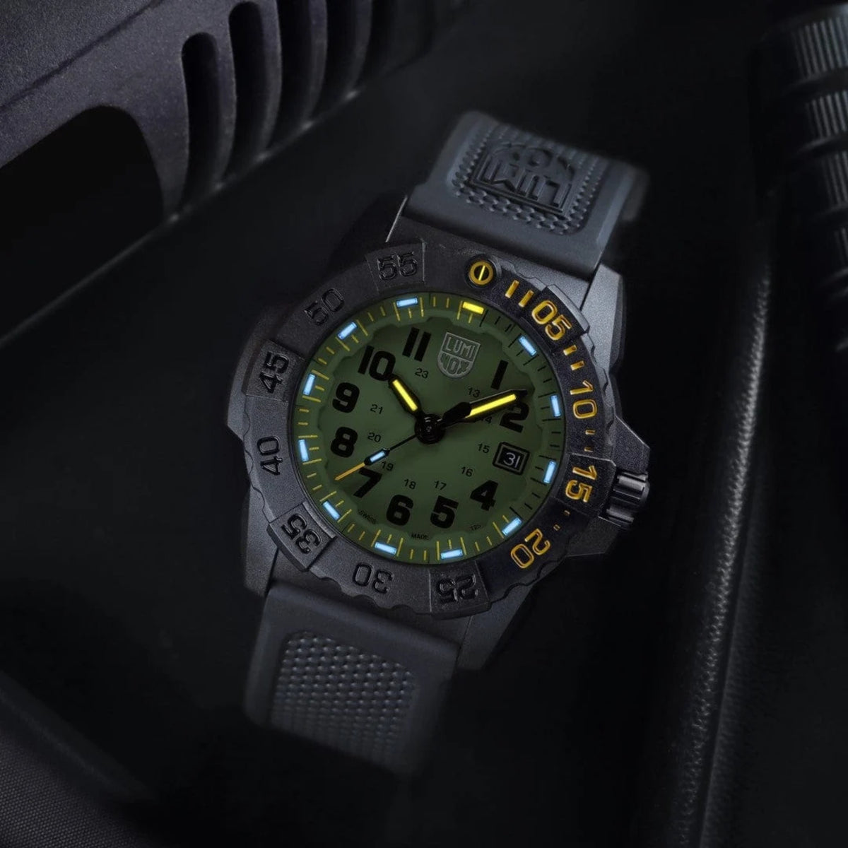 Close-up of Luminox Navy SEAL Foundation watch with green dial, yellow accents, and rubber strap