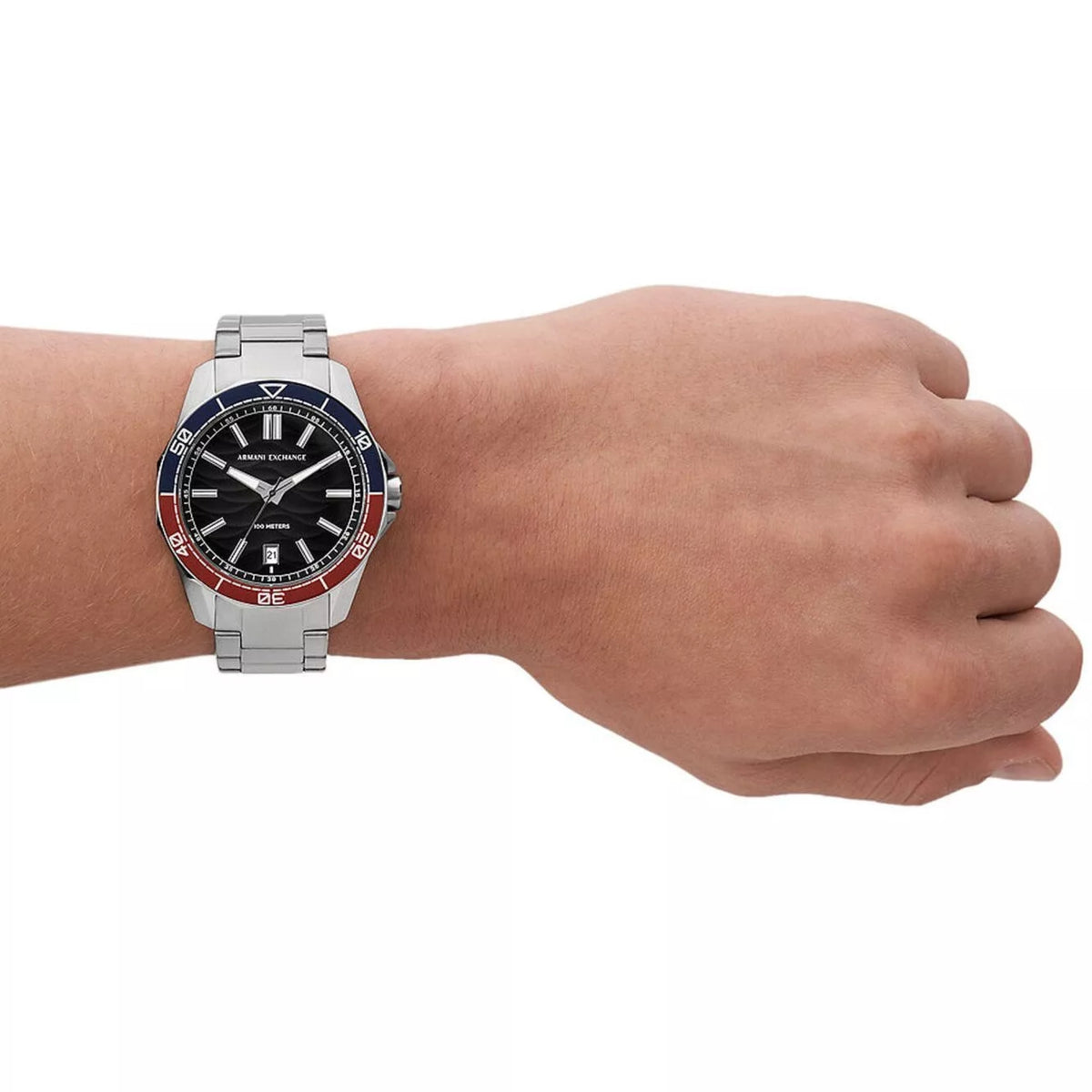 Stainless steel men’s quartz watch with black dial and red/blue bezel, on wrist