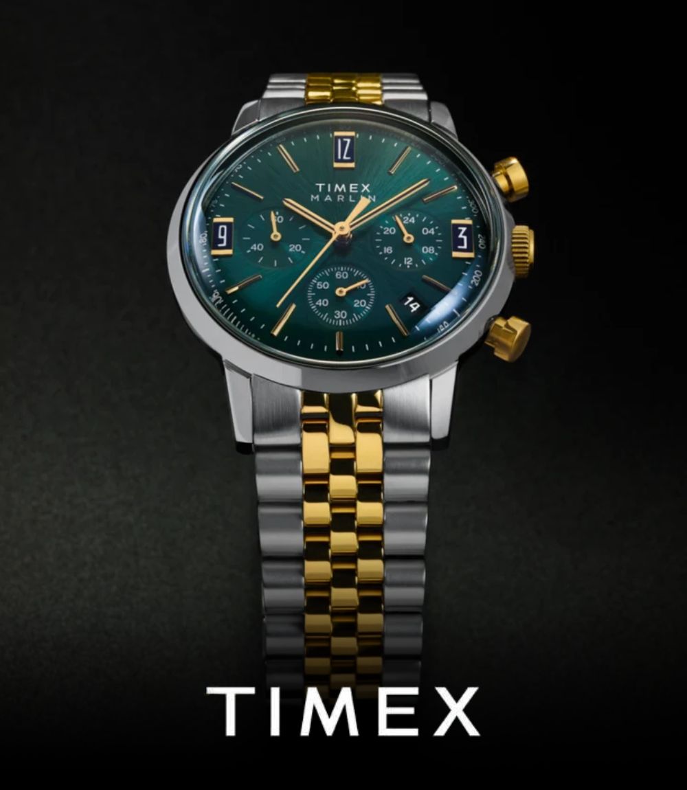 Timex Marlin chronograph watch set against a dark background, featuring a teal green dial with gold-tone sub-dials and accents, paired with a two-tone silver and gold stainless steel bracelet, featuring the Timex logo at the bottom