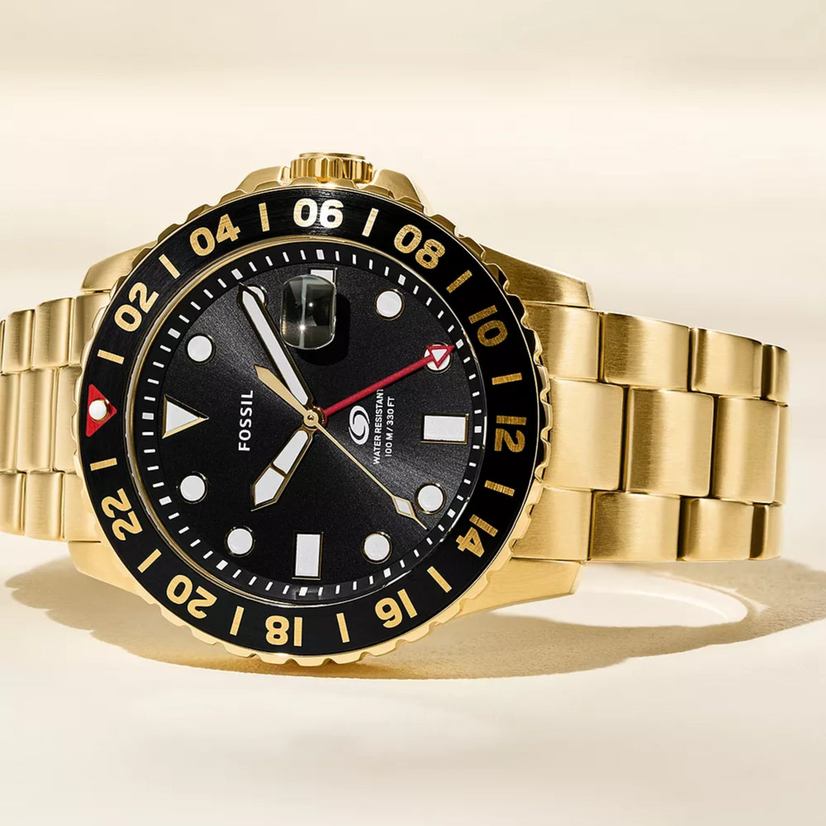 Close-up shot showing the black dial, red GMT hand, cyclops date window, and 24-hour bezel of the Fossil Blue GMT FS5990 wristwatch