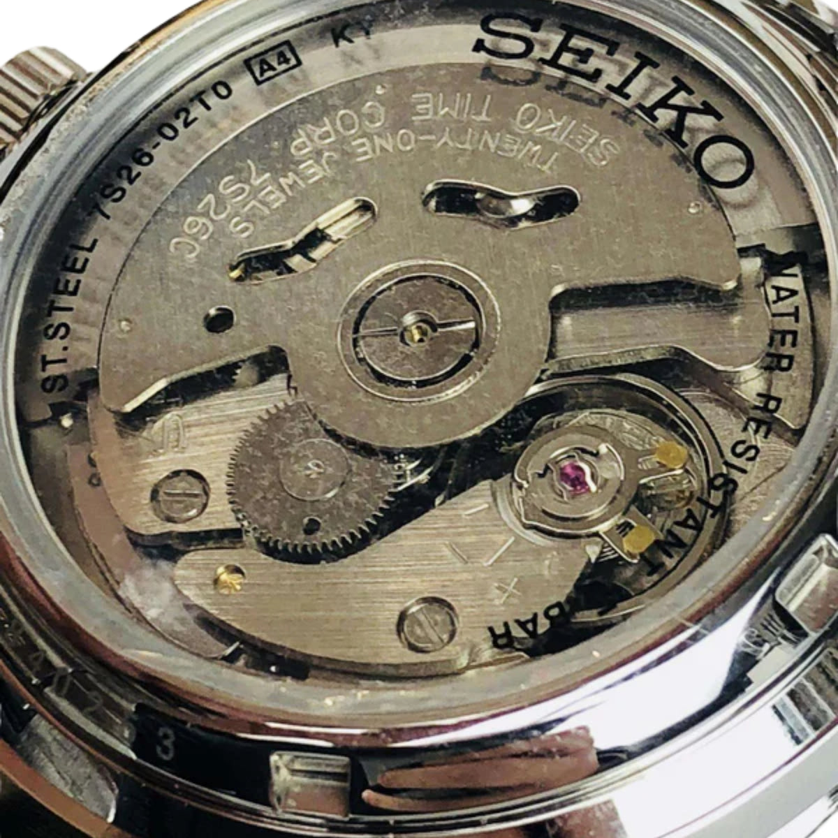 Seiko 5 men's automatic watch movement view through caseback, stainless case