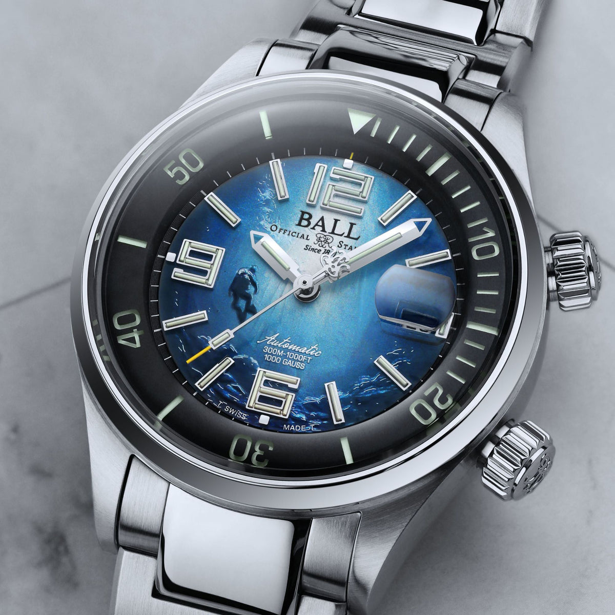 Side angled shot of BALL 42mm blue dial automatic diver watch with polished stainless steel bracelet and screw-down crown