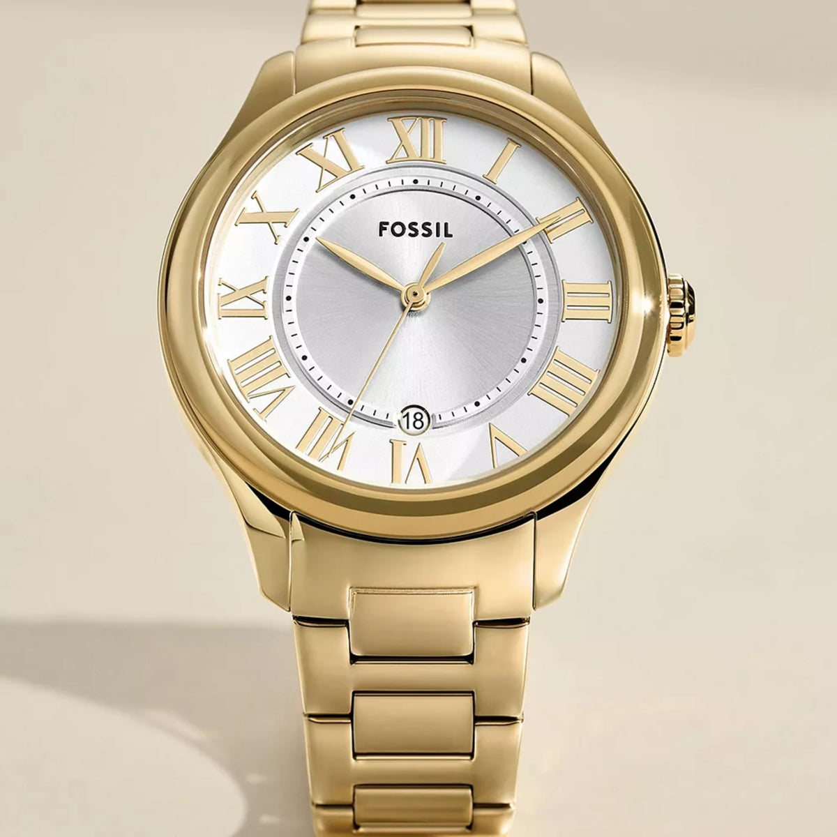 Gold-tone watch with white dial, Roman numerals, gold hands and date window