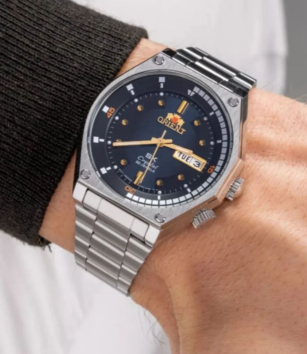 Orient Neo Classic crystal watch featuring a navy dial with gold-tone hands on a stainless steel bracelet
