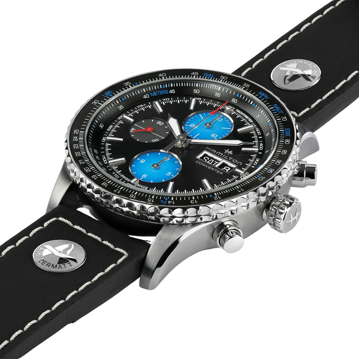 Men's automatic pilot watch angled view with black dial, blue subdials, and leather strap