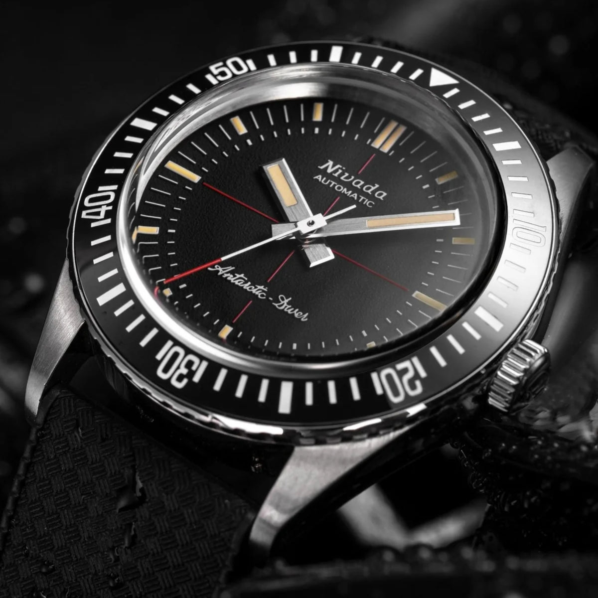 Front close-up of black dial diver watch with silver hands, baton markers, and date window