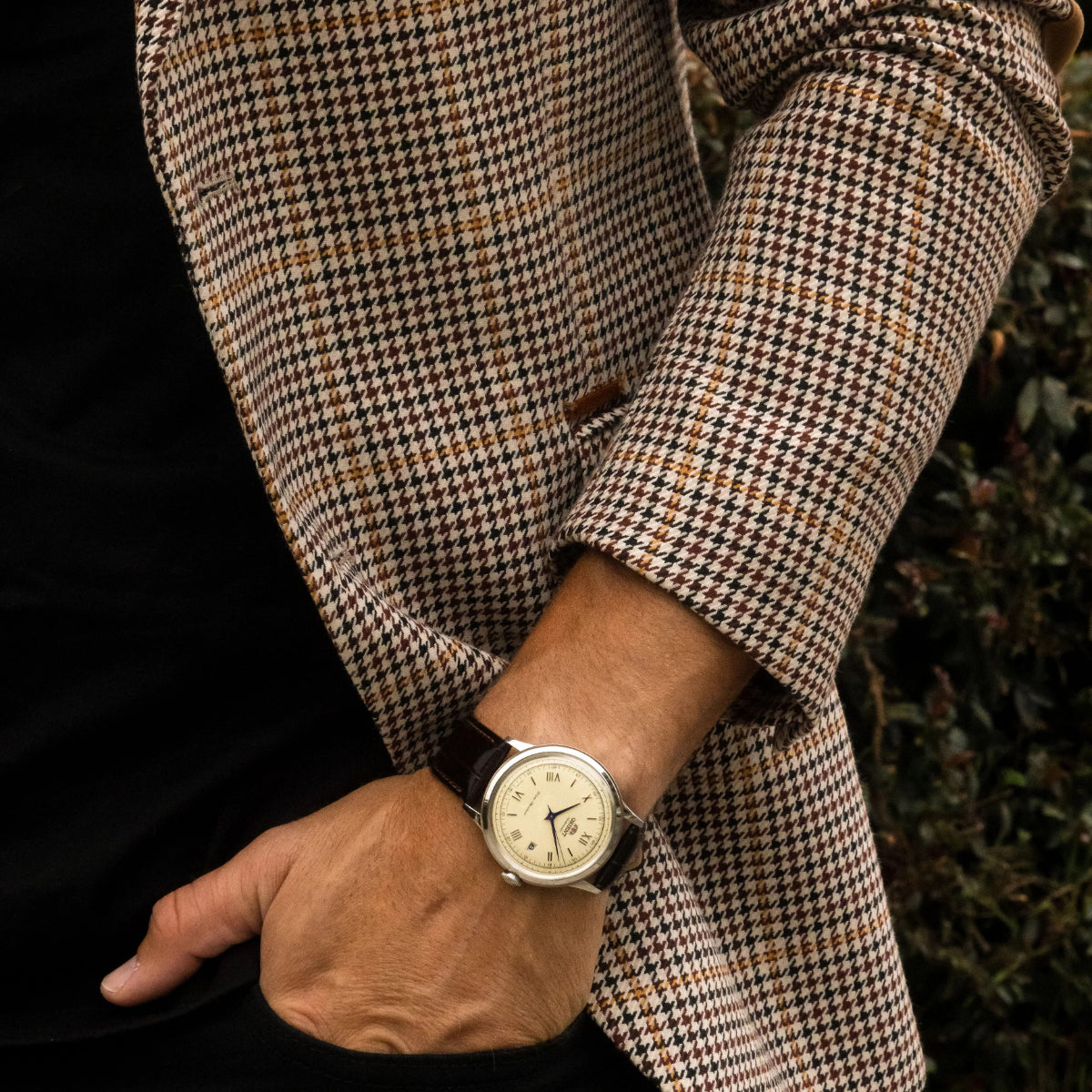 Orient Bambino TAC00009N0 on the wrist showing its champagne dial and brown leather strap