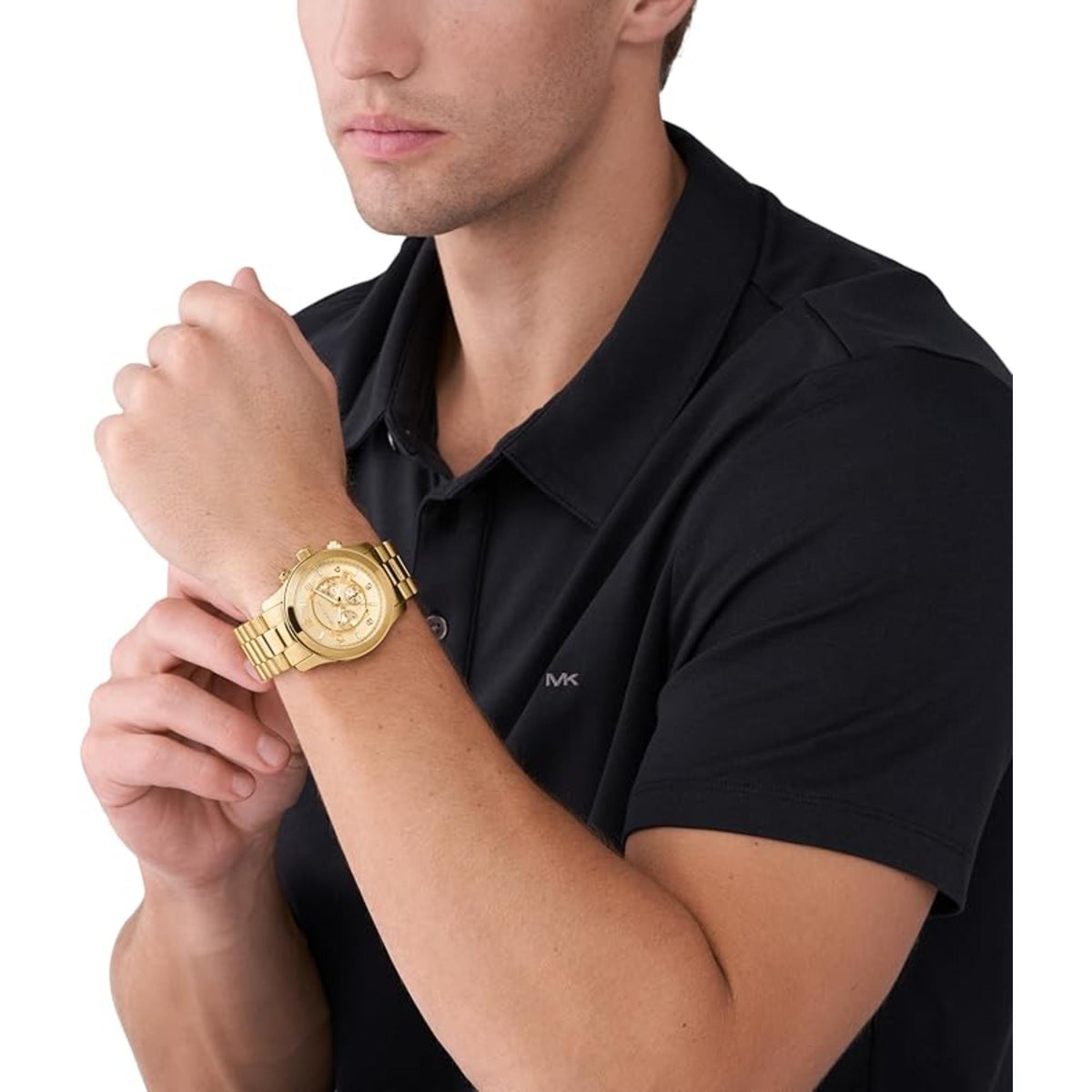Men’s gold chronograph wristwatch with steel bracelet, worn on arm near polo shirt.