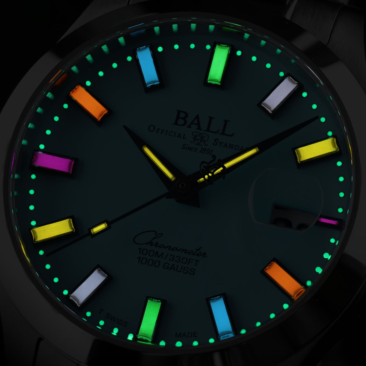 Men’s watch with dark dial and multicolor luminous hour markers, baton indices, chrono marks