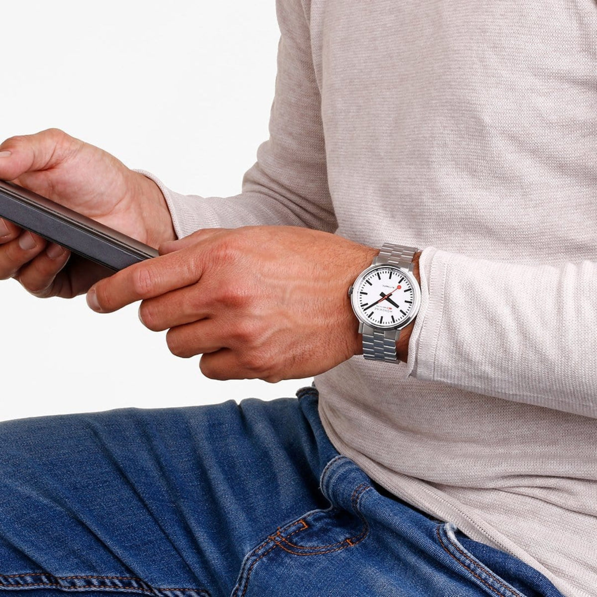 Stainless steel automatic watch on wrist with white dial and metal bracelet