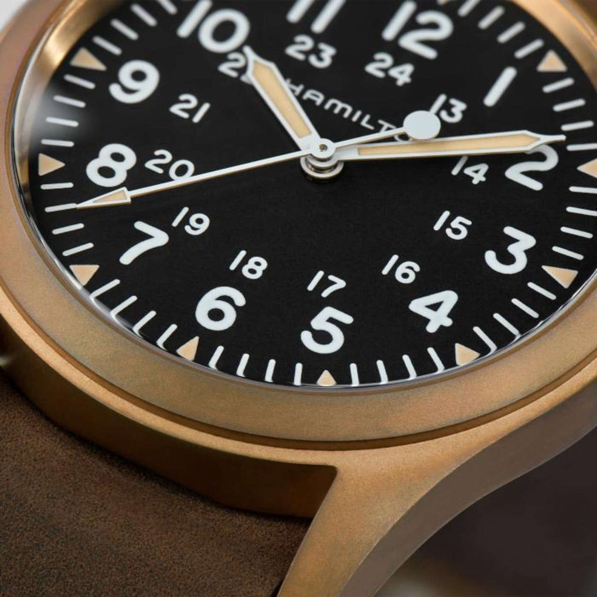 Hamilton Khaki Field H69459530 bronze mechanical wristwatch macro close-up highlighting black dial with 24-hour markings and luminescent hands