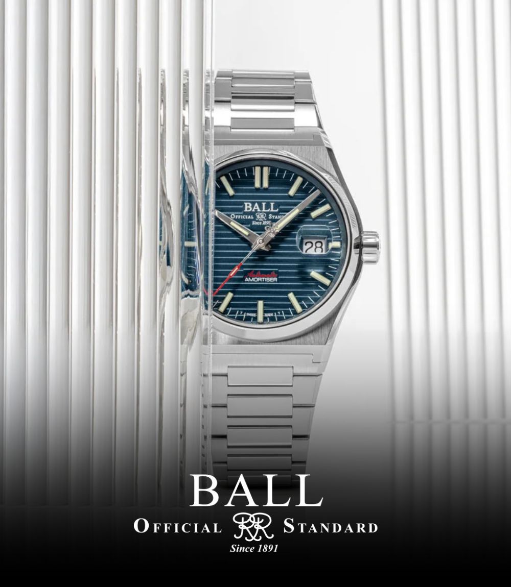 Ball Official Standard automatic watch partially framed behind fluted glass, featuring a stainless steel case and integrated bracelet with a teal textured horizontal-striped dial and date display, featuring the Ball logo at the bottom