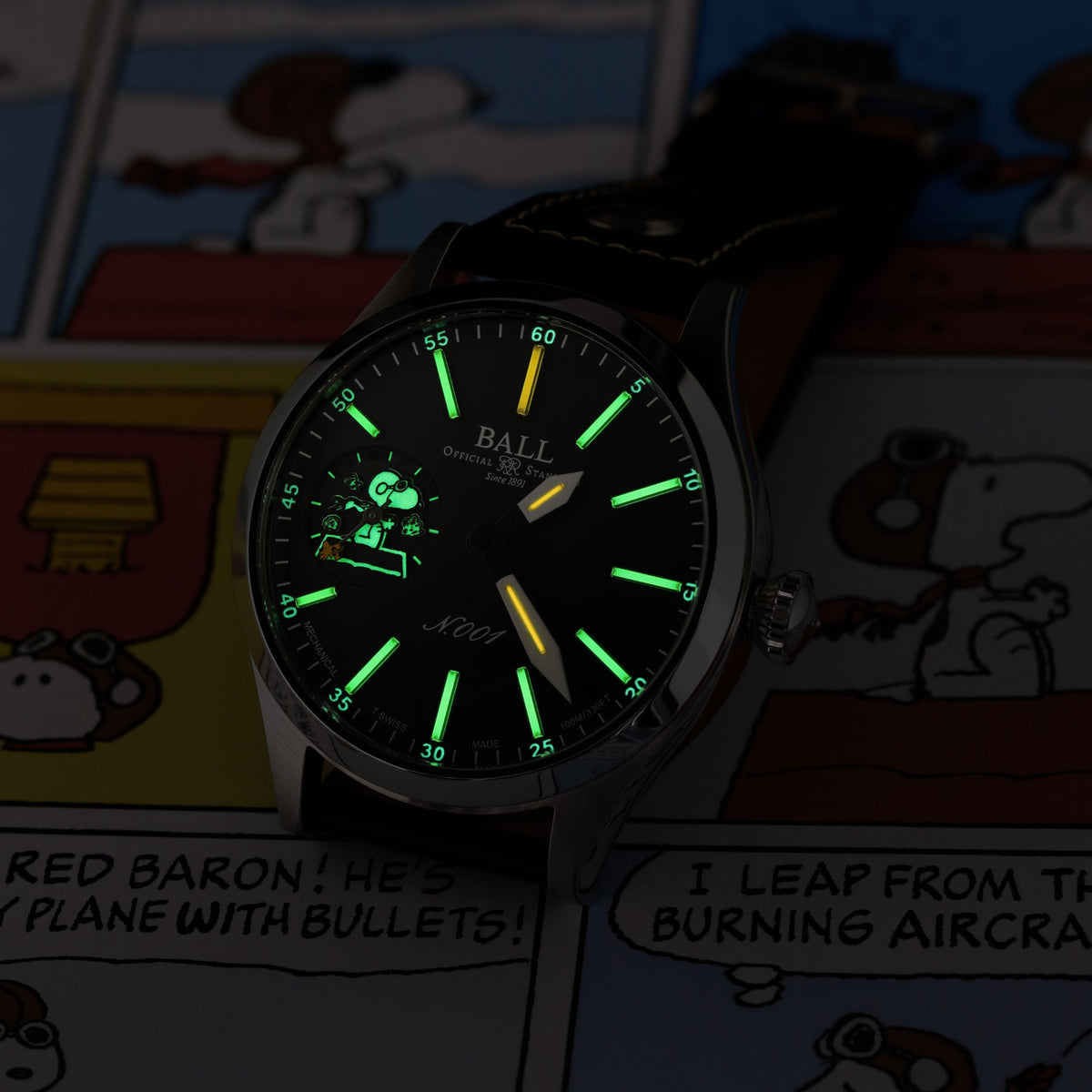 Men's manual-wind wristwatch with green luminous markers on black dial and black leather strap.