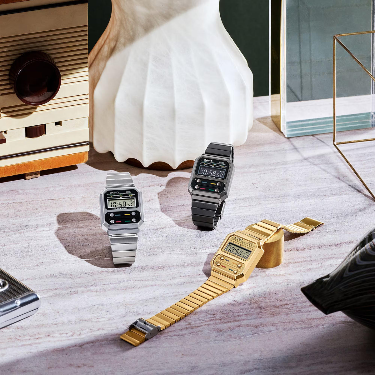 Casio digital watch with silver steel bracelet displayed among other watches