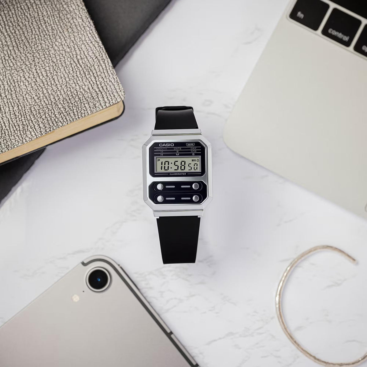 Casio vintage digital watch with black resin strap and silver case, LCD display