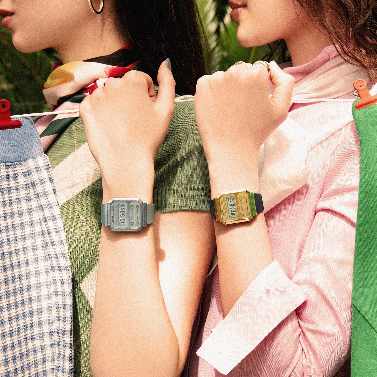 Gold-tone digital watch worn on wrist with dark silicone strap