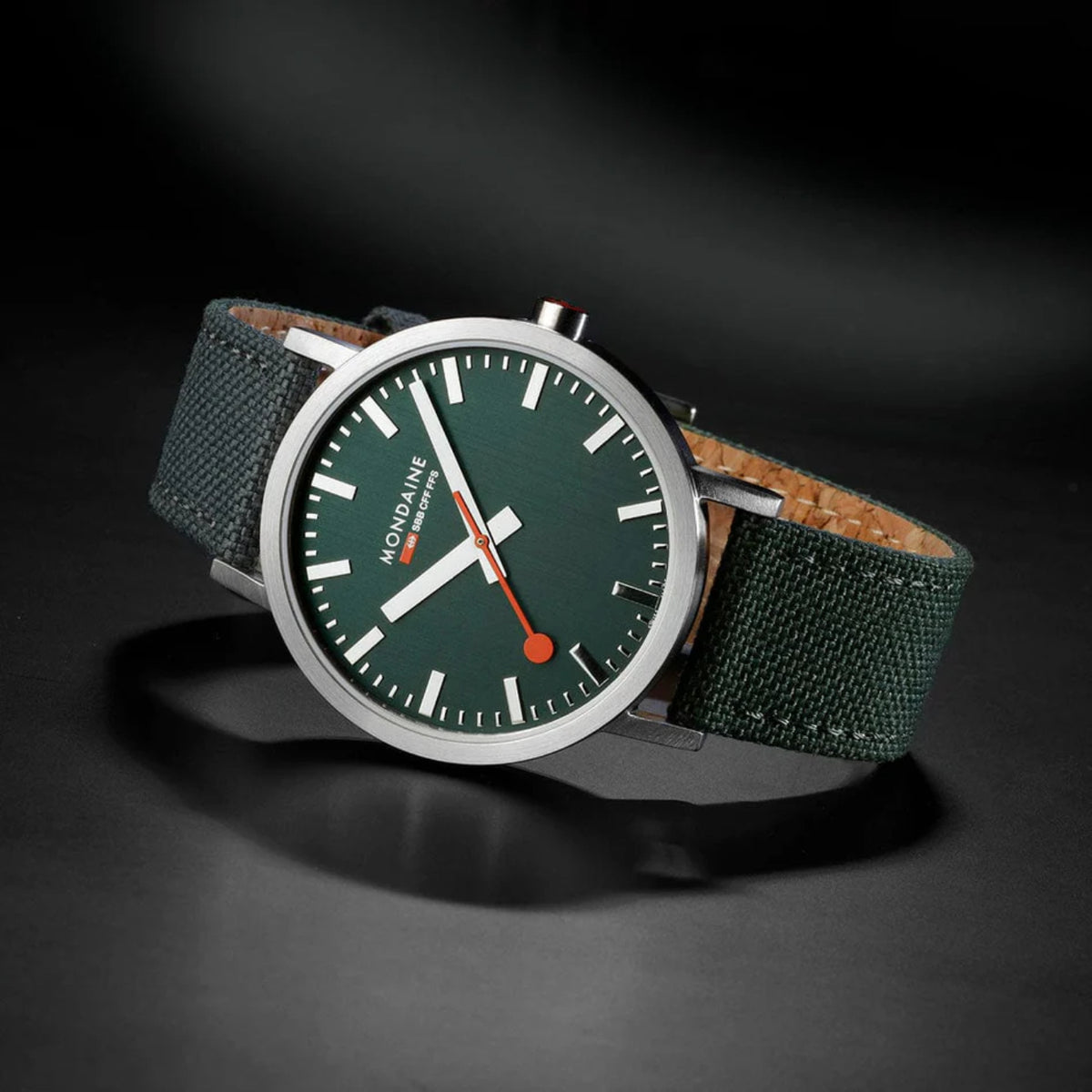 Mondaine watch featuring forest green dial and matching green canvas textile strap