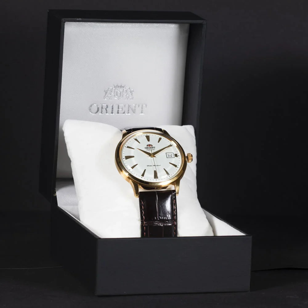 Orient men's automatic watch with white dial and brown leather strap on display