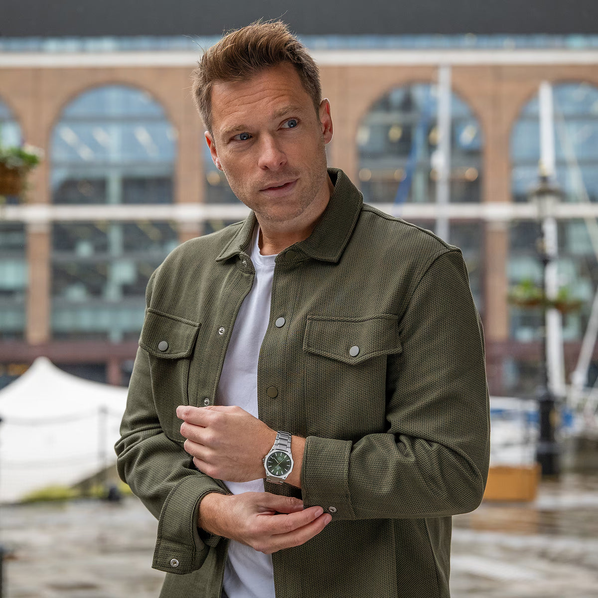 Model wearing an olive jacket showcasing the Casio Edifice EFR-S108D-3AVUEF green dial watch outdoors
